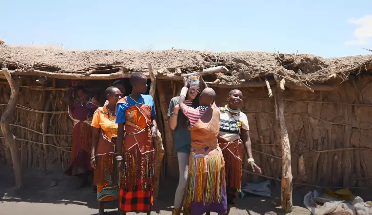 Datoga Tribe Women giving traditional gifts to female Tourist