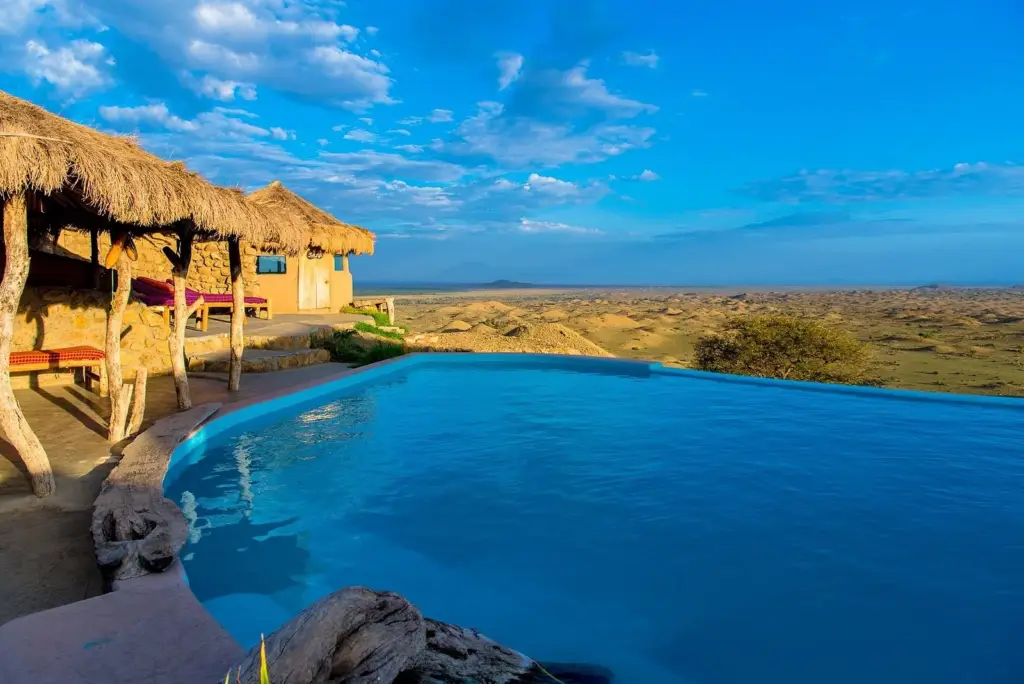 Infinity pool at Africa Amini Maasai Lodge overlooking a vast savanna