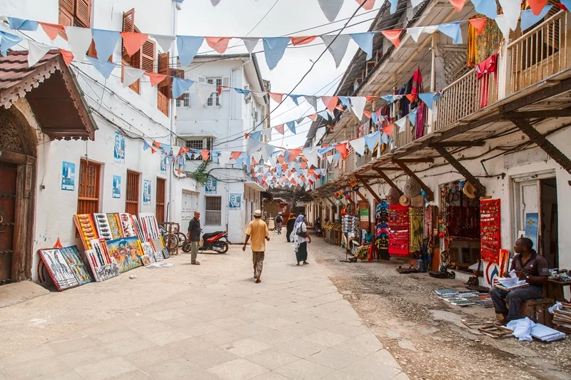 Allée de marché artisanal ornée de tissus et de peintures