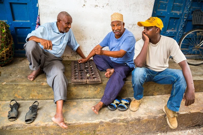 Men playing a game of bao