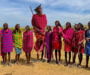 Group of people in traditional Maasai attire standing outdoors