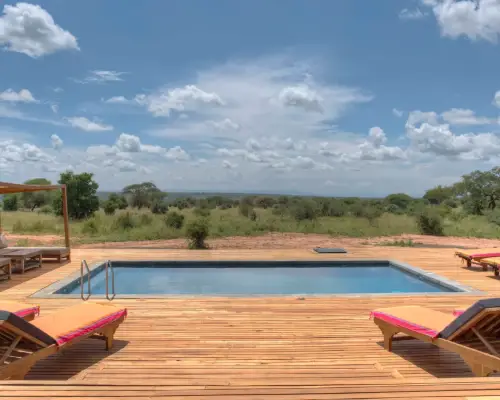 Tarangire Ndovu Pool: outdoor pool with sun loungers, wooden deck, and savannah view