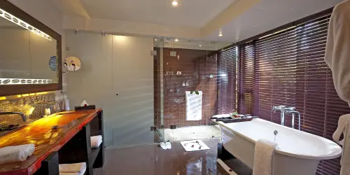 Beautiful Bathroom with white tub at arusha coffee lodge plantation suite