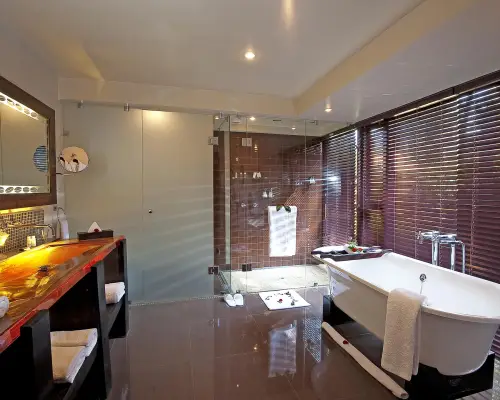 Beautiful Bathroom with white tub at arusha coffee lodge plantation suite