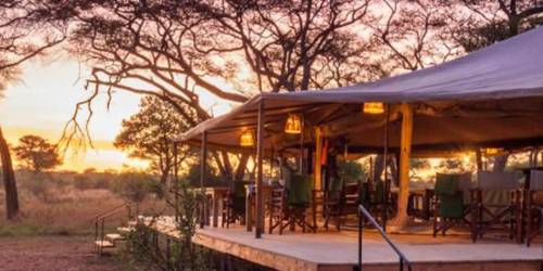 The outside view of the Baobab Tented Camp at the sunset time