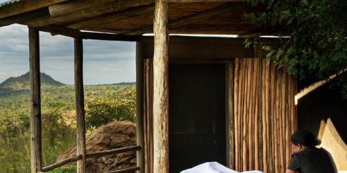An outdoor massage setup on a wooden deck with a scenic natural backdrop
