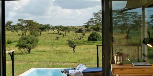 Elegant room interior with pool overlooking a savanna landscape at Lemala Nanyukie Lodge