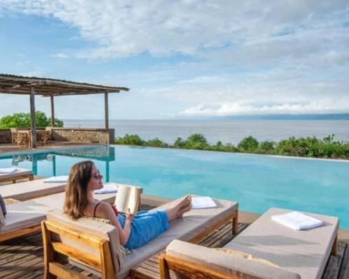 Tourist Enjoying at Manyaras Sected Lodge main pool with a beautiful outdoor natural view