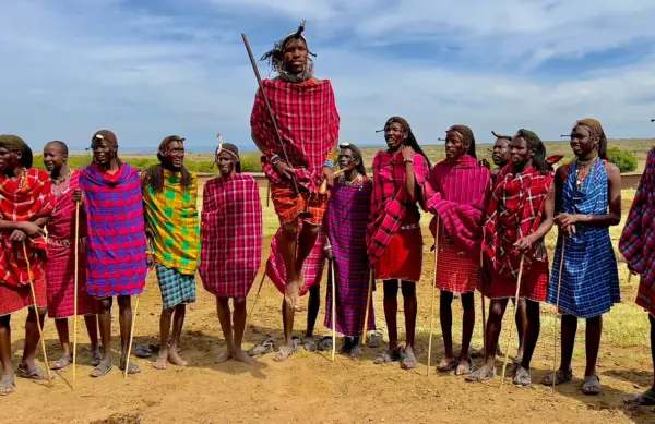 Group of people in traditional Maasai attire standing outdoors